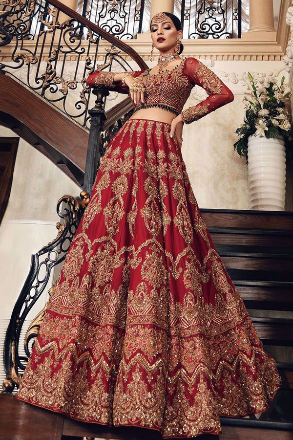 Uroos-e-Khas  A vision of opulence and grace, this masterpiece celebrates the grandeur of timeless bridal heritage. Rich crimson tones meet intricate hand-embellished artistry, woven with shimmering embellishments to create a silhouette that whispers of royal charm. Each detail tells a story of elegance, designed for the bride who wishes to embody both tradition and allure on her most special day.